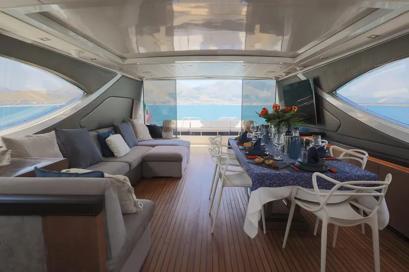 @last Yacht Photos Pics Luxurious interior of 2003 Leopard 24 yacht with elegant dining setup and ocean view.