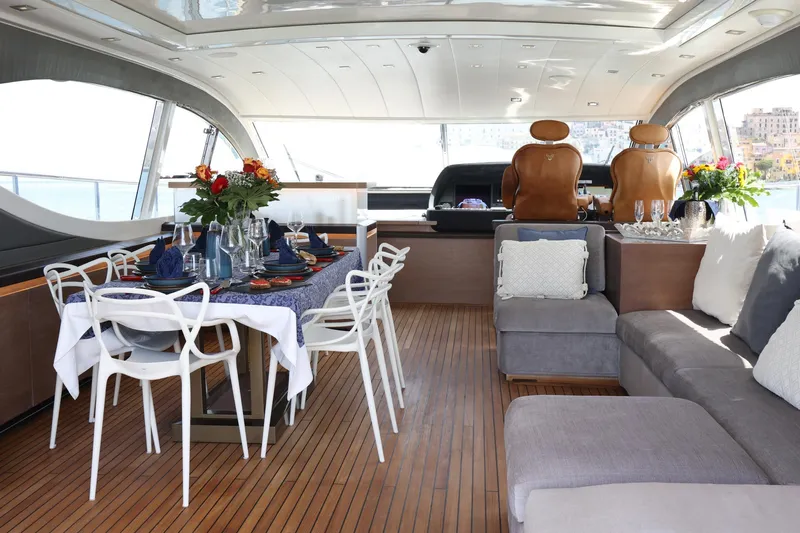 @last Yacht Photos Pics Luxurious interior of 2003 Leopard 24 yacht with elegant dining setup and plush seating.