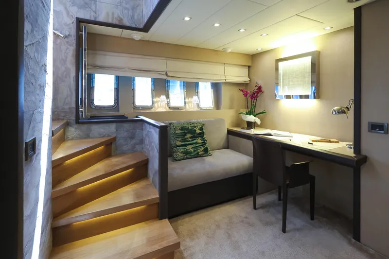 @last Yacht Photos Pics Luxurious interior of 2003 Leopard 24 yacht with elegant seating and desk area.