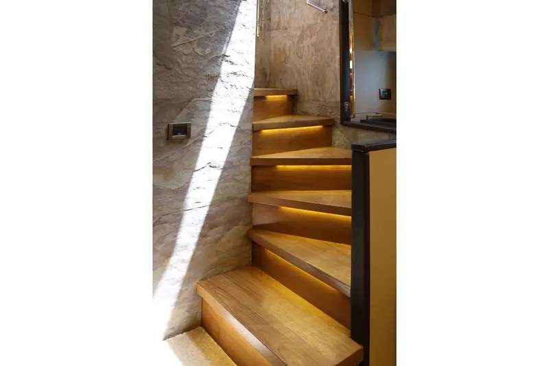 @last Yacht Photos Pics Illuminated wooden staircase in 2003 Leopard 24 yacht interior.