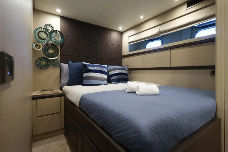 @last Yacht Photos Pics Luxurious bedroom interior of 2003 Leopard 24 yacht with modern decor and cozy bedding.