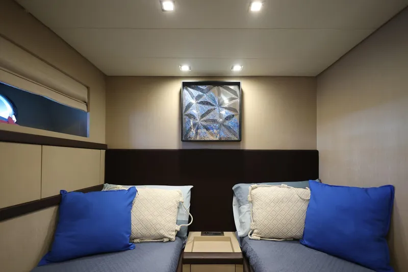 @last Yacht Photos Pics Interior of 2003 Leopard 24 yacht with twin beds and modern decor.