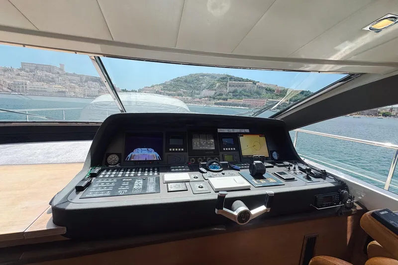 @last Yacht Photos Pics Cockpit view of 2003 Leopard 24 yacht with scenic coastal backdrop.