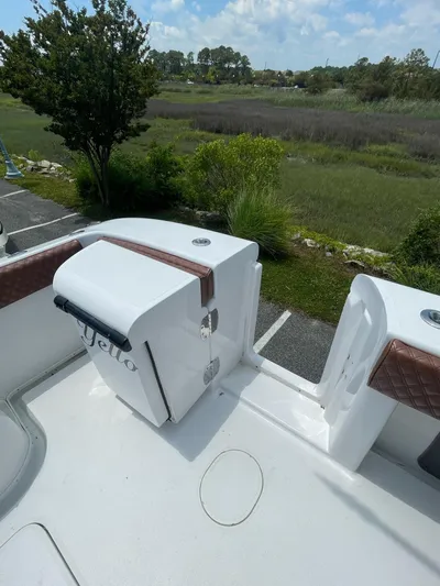  Yacht Photos Pics 2008 Yellowfin 42 boat deck with storage, overlooking lush greenery and blue sky.