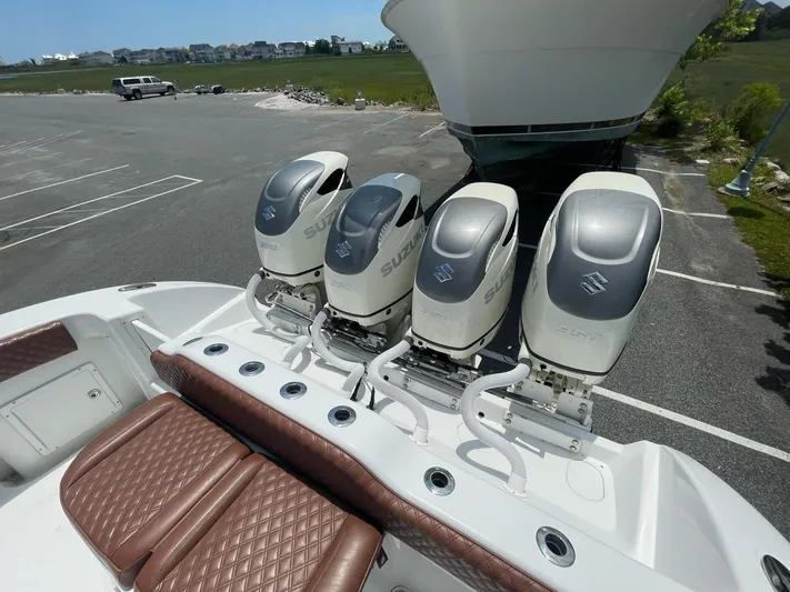  Yacht Photos Pics Four Suzuki outboard motors on a 2008 Yellowfin 42 boat in a parking lot.
