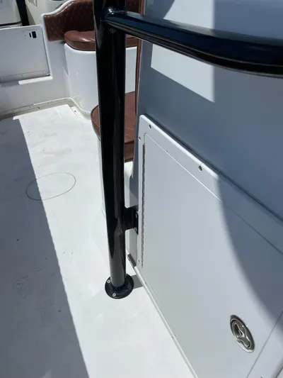  Yacht Photos Pics 2008 Yellowfin 42 boat interior with black railing and white storage compartment.