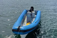 Blue 2019 One Design ST-R boat docked in a calm marina.