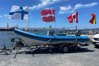 2019 One Design ST-R boat on trailer with flags, dockside view.