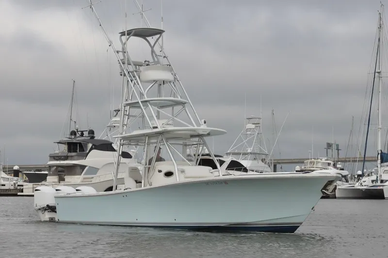  Yacht Photos Pics 2015 Regulator 34 boat docked in marina, overcast sky, surrounded by other vessels.