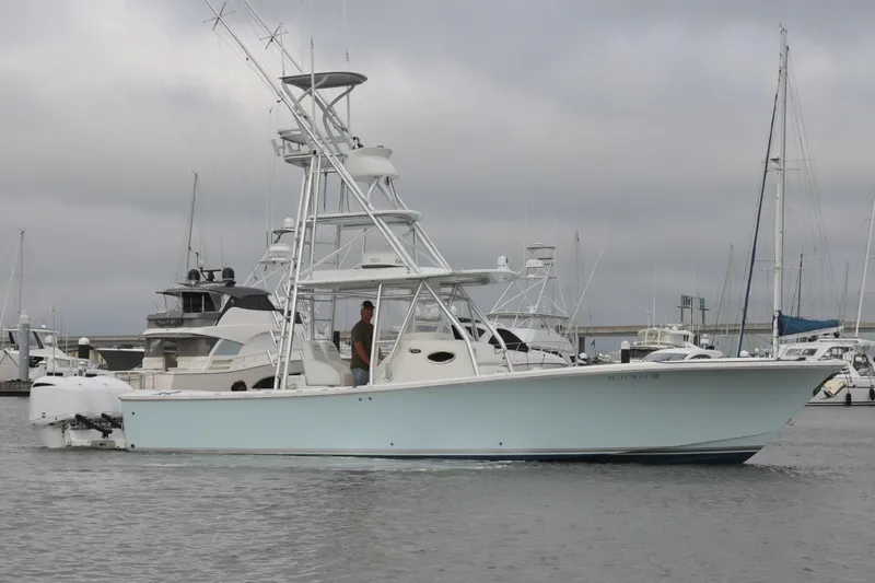  Yacht Photos Pics 2015 Regulator 34 boat docked in marina, featuring fishing tower and twin engines.