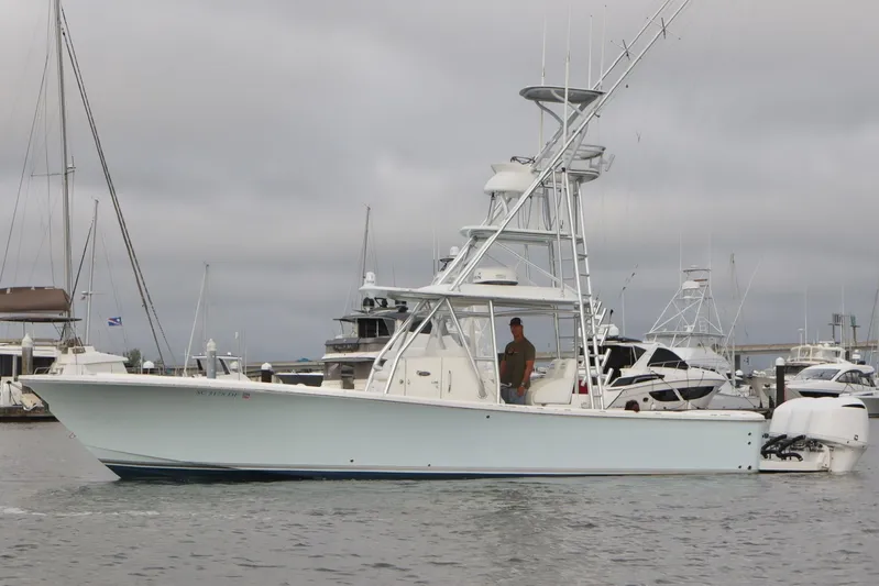  Yacht Photos Pics 2015 Regulator 34 boat docked in a marina with overcast skies.