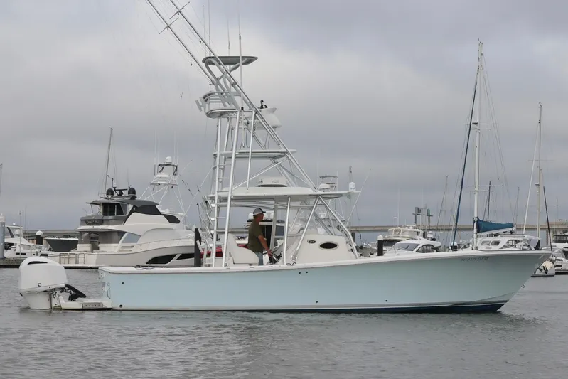  Yacht Photos Pics 2015 Regulator 34 boat docked in a marina with overcast skies.