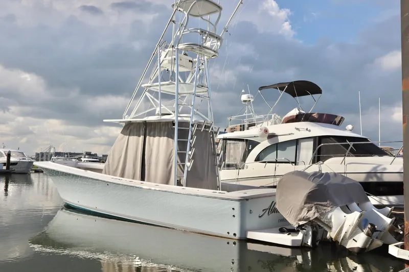  Yacht Photos Pics 2015 Regulator 34 boat docked at marina under cloudy sky.