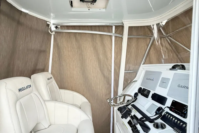  Yacht Photos Pics 2015 Regulator 34 boat interior with Garmin navigation system and white seating.