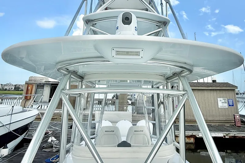  Yacht Photos Pics 2015 Regulator 34 boat with tower, docked at marina under clear sky.