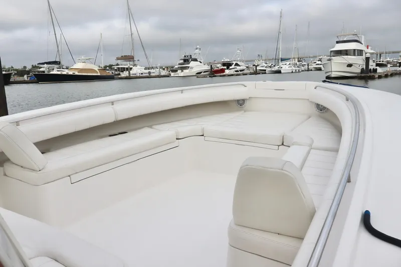  Yacht Photos Pics 2015 Regulator 34 boat with spacious seating, docked in a marina with other yachts.