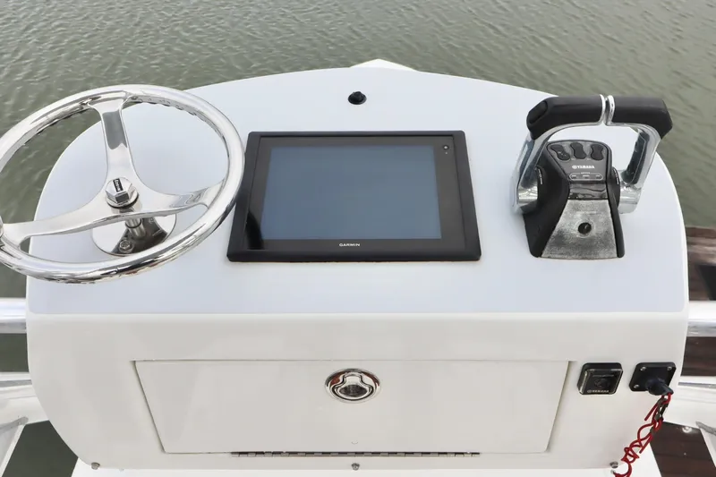  Yacht Photos Pics Control panel of a 2015 Regulator 34 boat with steering wheel and Garmin display.