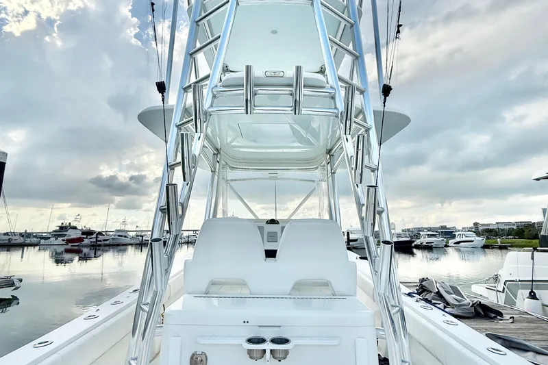  Yacht Photos Pics 2015 Regulator 34 boat with tower, docked in a marina under cloudy skies.