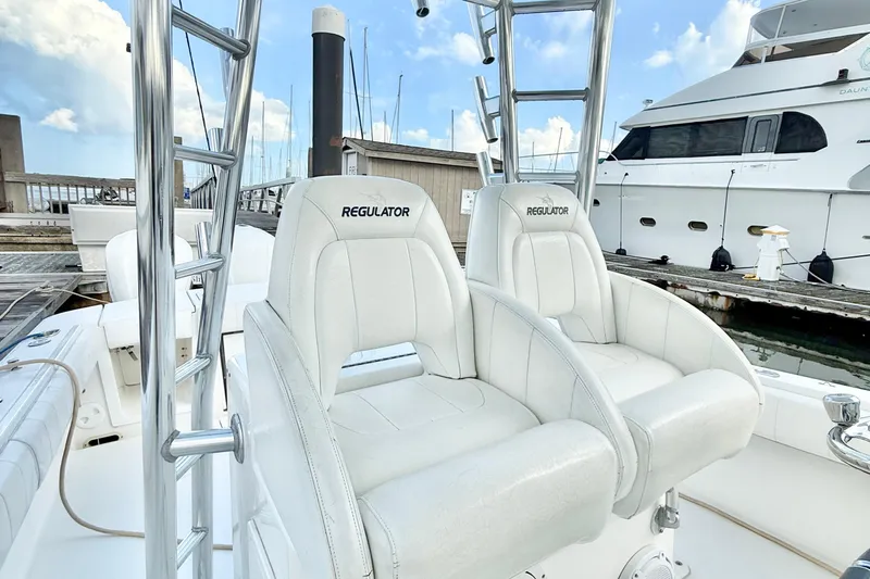  Yacht Photos Pics 2015 Regulator 34 boat with white seating at a marina dock.