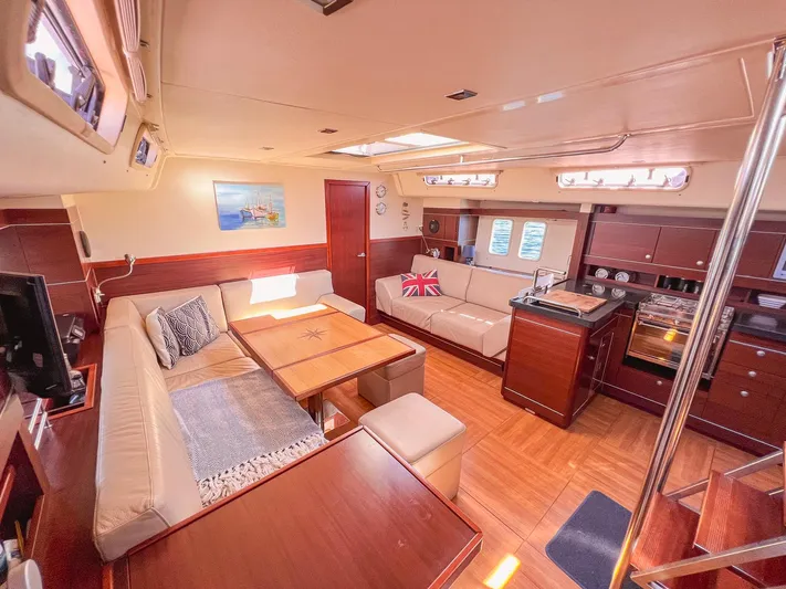  Yacht Photos Pics Luxurious interior of 2010 Hanse 545 yacht with elegant wood finishes and cozy seating.