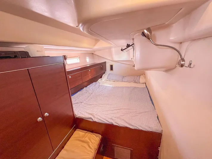  Yacht Photos Pics Cozy cabin interior of 2010 Hanse 545 yacht with bed and wooden cabinetry.