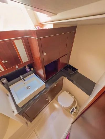  Yacht Photos Pics Luxurious bathroom in 2010 Hanse 545 yacht with modern sink and wooden cabinetry.