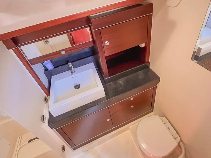  Yacht Photos Pics Bathroom interior of 2010 Hanse 545 yacht with sink, mirror, and toilet.