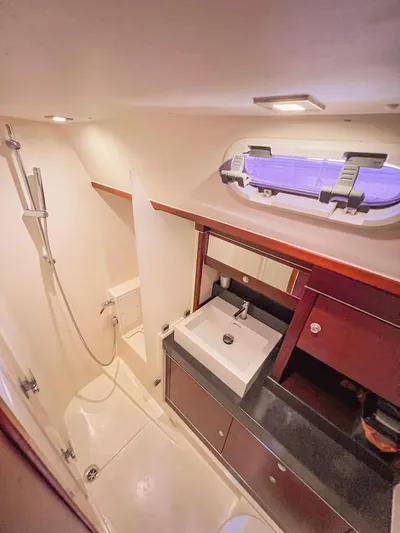  Yacht Photos Pics Luxurious bathroom in 2010 Hanse 545 yacht with modern fixtures and porthole window.