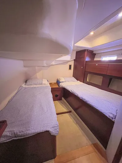  Yacht Photos Pics Interior of 2010 Hanse 545 yacht with twin beds and wooden cabinetry.