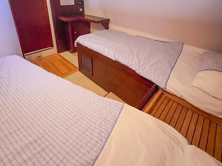  Yacht Photos Pics Twin cabin beds in a 2010 Hanse 545 yacht, featuring cozy bedding and wooden accents.