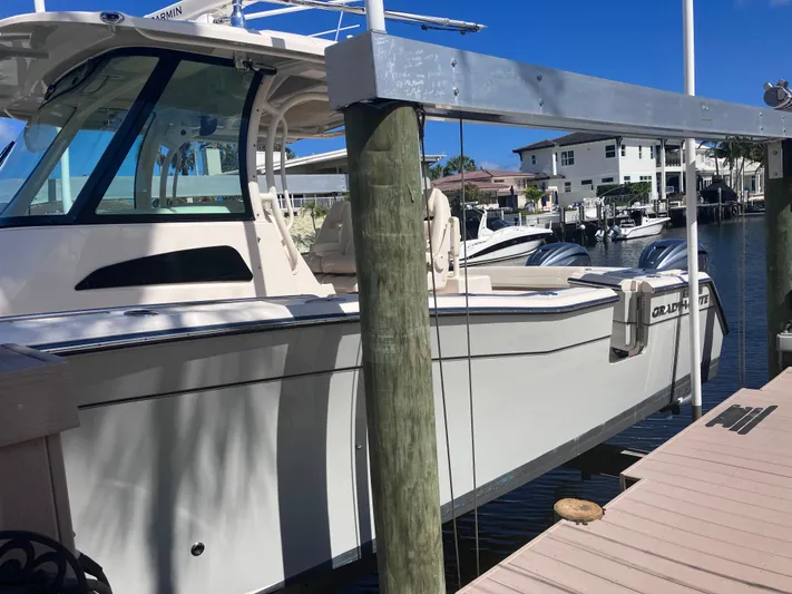  Yacht Photos Pics 2020 Grady-White Canyon 336 boat docked at marina under clear blue sky.