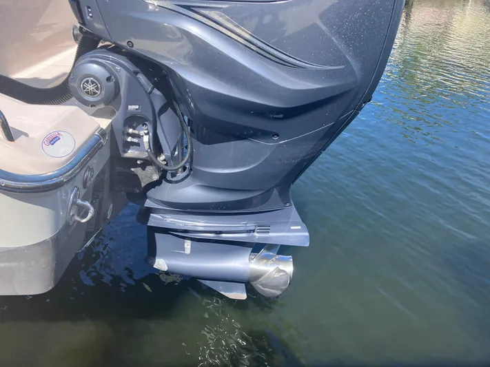  Yacht Photos Pics 2020 Grady-White Canyon 336 boat engine in water, showcasing sleek design and power.