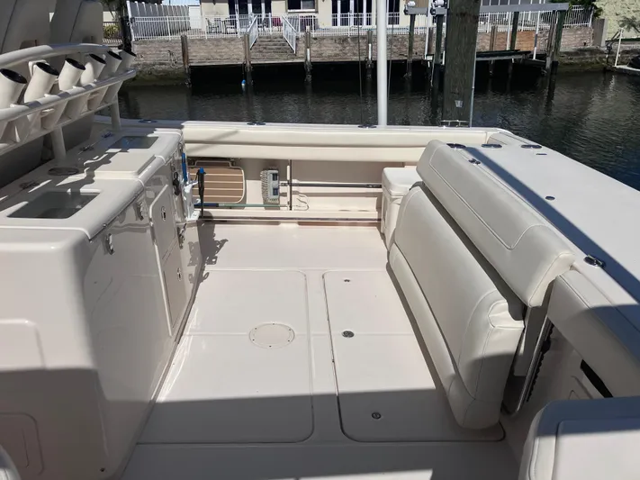  Yacht Photos Pics 2020 Grady-White Canyon 336 boat interior with seating and storage, docked by the water.