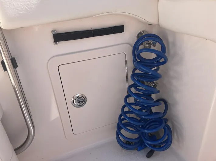  Yacht Photos Pics 2020 Grady-White Canyon 336 boat compartment with coiled blue hose.