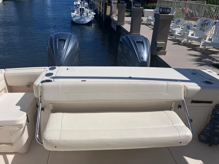  Yacht Photos Pics 2020 Grady-White Canyon 336 boat with dual engines, docked by a marina.