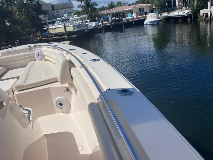  Yacht Photos Pics 2020 Grady-White Canyon 336 boat docked by a serene waterfront.
