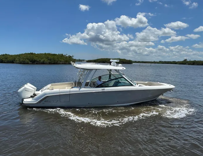  Yacht Photos Pics 2023 Boston Whaler 320 Vantage boat cruising on a sunny day with clear skies.