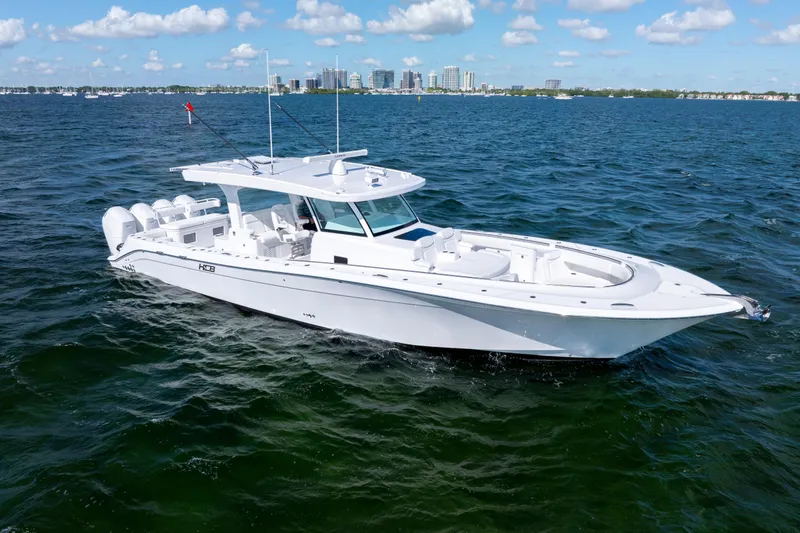  Yacht Photos Pics 2026 HCB 48 Campeon boat on open water, clear sky, city skyline in background.