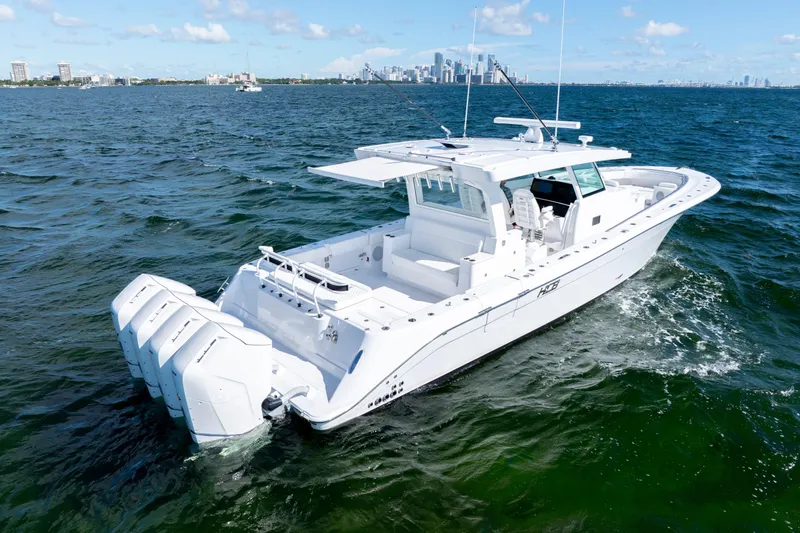  Yacht Photos Pics 2026 HCB 48 Campeon boat cruising on open water with city skyline in background.