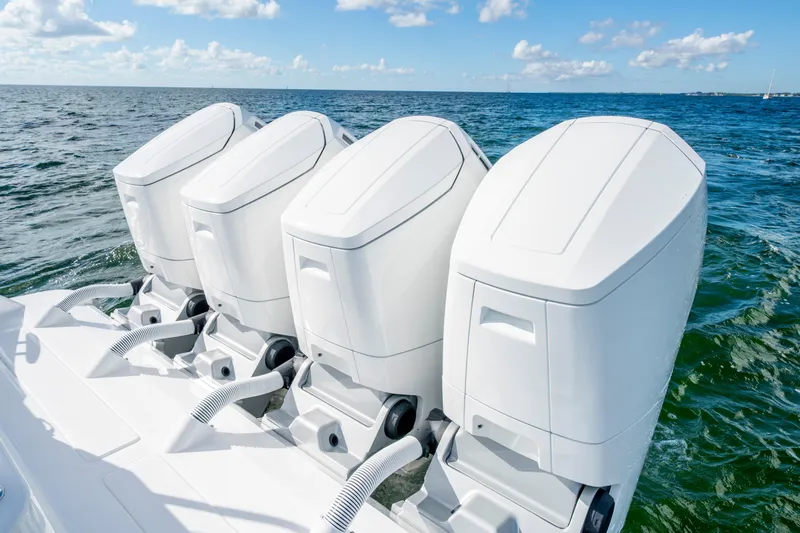  Yacht Photos Pics Four powerful outboard engines on a 2026 HCB 48 Campeon boat in open water.