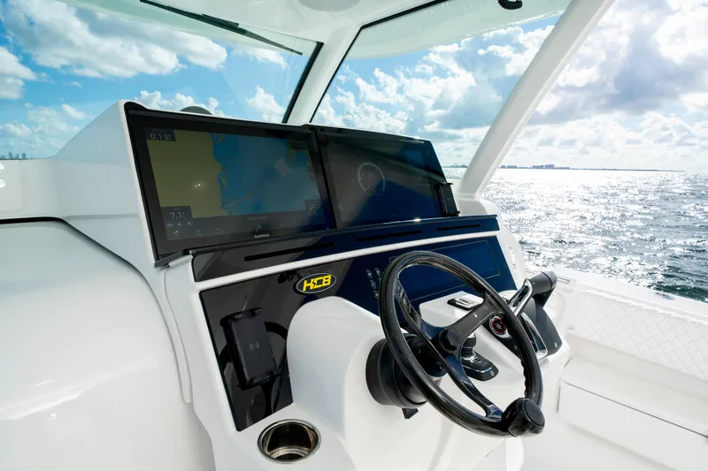  Yacht Photos Pics Helm of 2026 HCB 48 Campeon boat with modern navigation screens and steering wheel.