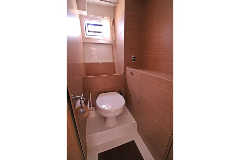  Yacht Photos Pics Modern bathroom in 2025 Lagoon 43 yacht with wood paneling and compact design.