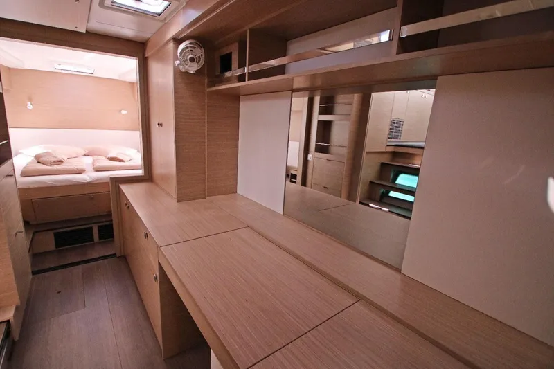  Yacht Photos Pics Luxurious interior of 2025 Lagoon 43 yacht with modern wood finish and cozy bedroom.