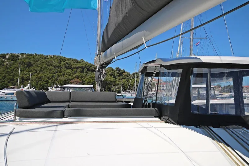  Yacht Photos Pics 2025 Lagoon 43 yacht with sleek design, spacious deck, and luxurious seating in a marina setting.