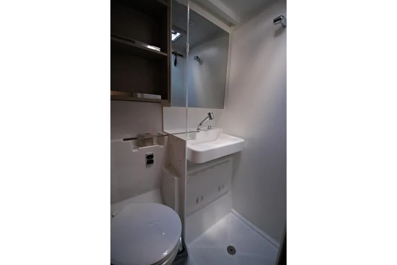  Yacht Photos Pics Modern bathroom interior of 2025 Lagoon 43 yacht, featuring sleek sink and mirror.