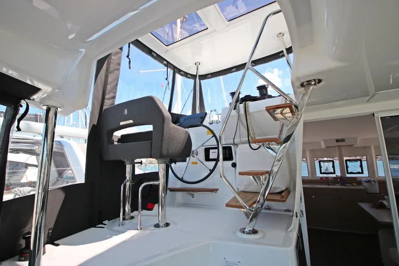  Yacht Photos Pics Interior view of 2025 Lagoon 43 yacht cockpit with modern steering and seating.