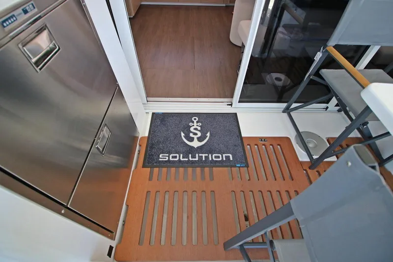  Yacht Photos Pics Interior of 2025 Lagoon 43 yacht with mat labeled "Solution" and modern furnishings.