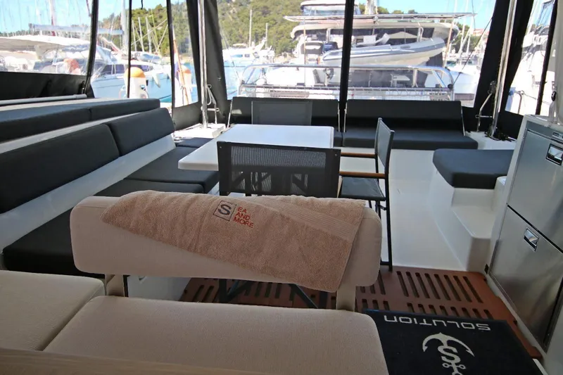  Yacht Photos Pics Luxurious interior of 2025 Lagoon 43 yacht with seating and dining area.