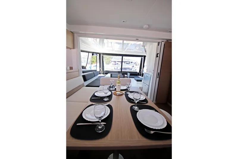  Yacht Photos Pics Luxurious interior of 2025 Lagoon 43 yacht with elegant dining setup and panoramic windows.