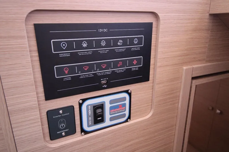  Yacht Photos Pics Control panel of 2025 Lagoon 43 yacht, featuring 12V DC system and inverter controls.